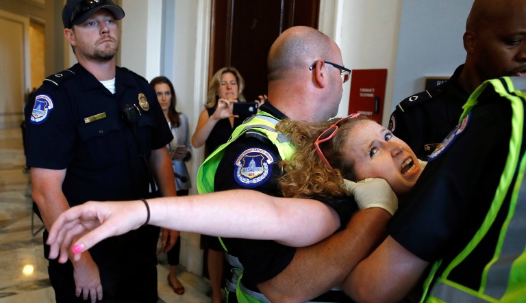 Protesters of the Senate GOP healthcare bill removed from their wheelchairs by police. (AP Photo/Jacquelyn Martin)