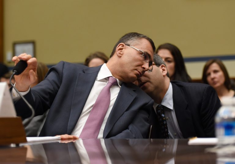 MIT economist Jonathan Gruber, left, huddles on Capitol Hill in Washington, Tuesday, Dec. 9, 2014, while testifying before the House Oversight Committee health care hearing. (AP Photo/Molly Riley)