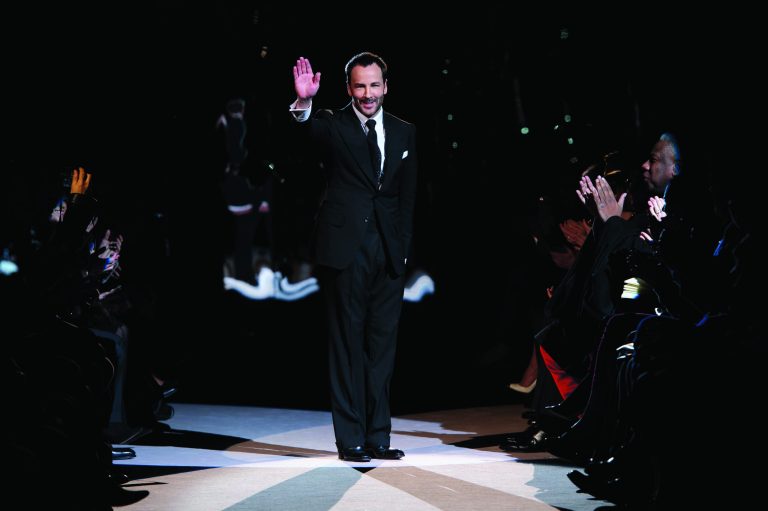 U.S fashion designer Tom Ford waves during his show at London Fashion Week, Monday, Feb. 18, 2013, London. (Photo by Jonathan Short/Invision/AP)