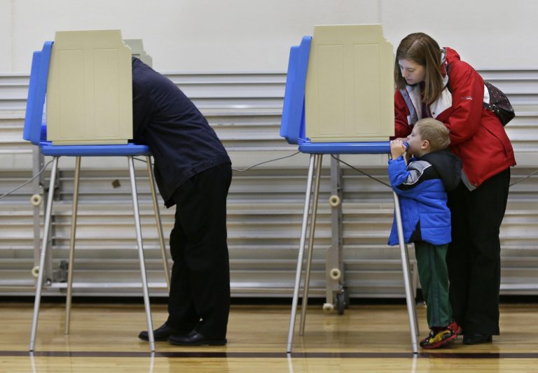 Appleton resident Barbara Caveny votes with her son, Ben, 4, at Fox Valley Lutheran High School on Election Day, Tuesday, Nov. 6, 2012 in Appleton, Wis.  (AP Photo/The Post-Crescent, Sharon Cekada)