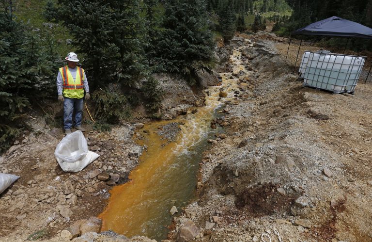 An EPA contractor works on the cleanup in the aftermath of the blowout at the Gold King mine, which triggered a major spill of toxic wastewater outside Silverton, Colo., Wednesday, Aug. 12, 2015. (AP Photo)Â 