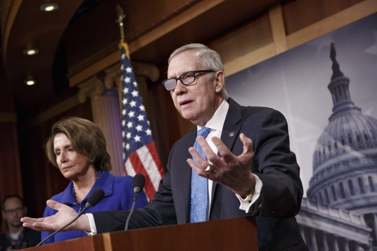 Senate Minority Leader Harry Reid of Nev., accompanied by House Minority Leader Nancy Pelosi of Calif., gestures during a news conference on Capitol Hill in Washington, Thursday, Feb. 26, 2015. (AP Photo/J. Scott Applewhite)