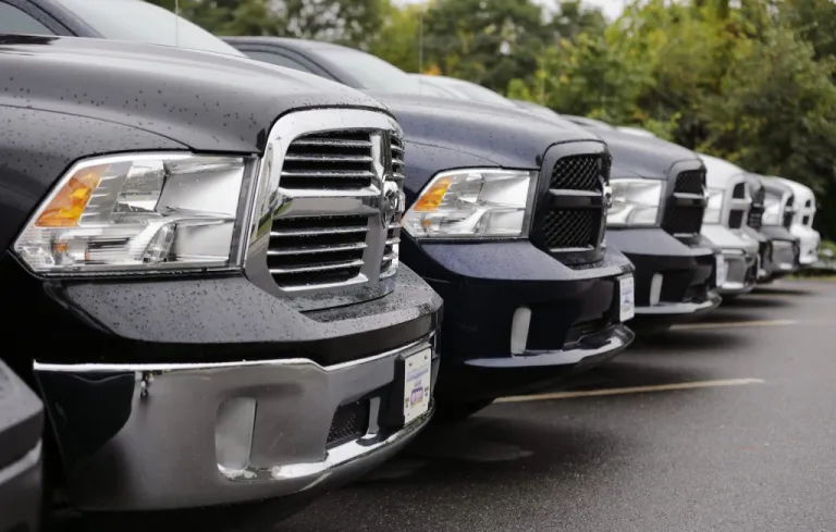 Dodge Ram pickup trucks are lined up for sale.
