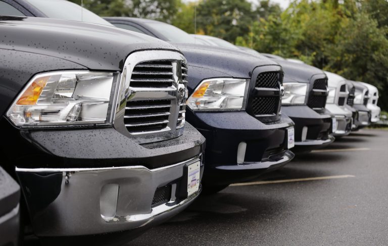 Dodge Ram pickup trucks are lined up for sale at Bill DeLuca's dealerships in Haverhill, Mass., Wednesday, Oct. 1, 2014. Chrysler Group says its U.S. sales rose 19 percent in September thanks to strong demand for the new Jeep Cherokee SUV and the Ram pickup. (AP Photo/Charles Krupa)
