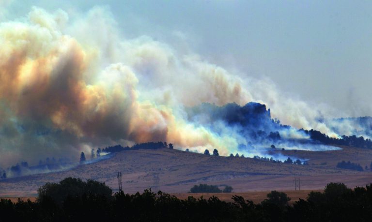 In this Saturday, Sept. 1, 2012 photo, smoke plumes rise from the West Ash Creek wildfire near Crawford Neb. The blaze is one of three wildfires burning in Nebraska and South Dakota, started earlier in the week by lightning. (AP Photo/Omaha World-Herald, Mark Davis) MAGS OUT; ALL NEBRASKA LOCAL BROADCAST TV OUT