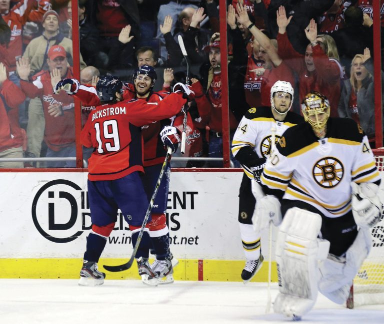 Alex Brandon/AP
Capitals right wing Eric Fehr celebrates with Nicklas Backstrom after his game-winning goal less than a minute into overtime.