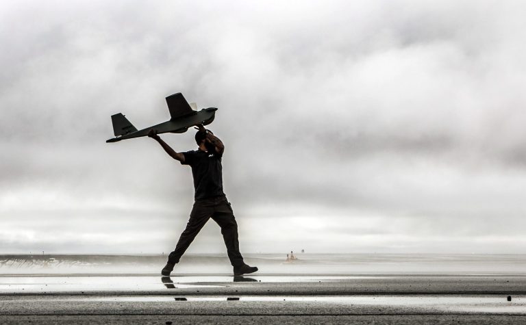 In this undated photo provided by AeroVironment, a man hand-launches a Puma drone aricraft. The Federal Aviation Administration (FAA) said Tuesday, June 10, 2014 it has granted the first permission for commercial drone flights over land, the latest effort by the agency to show it is loosening restrictions on commercial uses of the unmanned aircraft. Drone maker AeroVironment of Monrovia, Calif., and BP energy corporation have been given permission to use a Puma drone to survey pipelines, roads and equipment at Prudhoe Bay in Alaska, the agency said. The first flight took place on Sunday. The Puma is a small, hand-launched craft about 4 1/2 feet long and with a 9-foot wingspan. It was initially designed for military use. (AP Photo/AeroVironment)