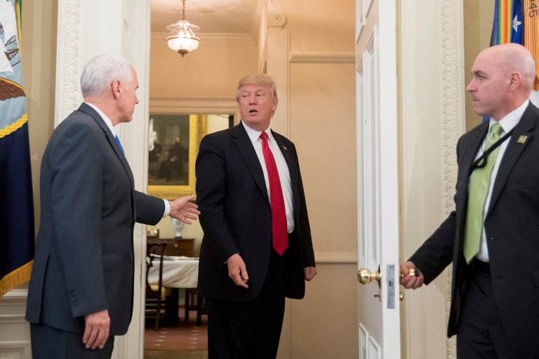 Vice President Mike Pence grabbed the orders and walked out of the room after the president. (AP Photo/Andrew Harnik)