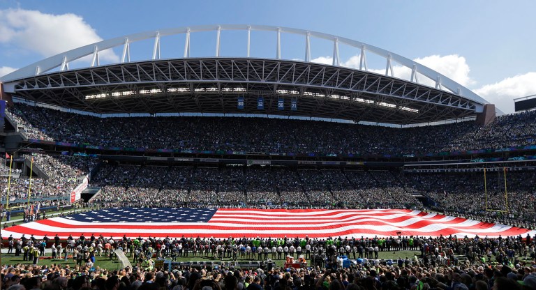 A U.S. flag fills the field at CenturyLink Field during the singing of the national anthem before an NFL football game between the Seattle Seahawks and the Miami Dolphins, Sunday, Sept. 11, 2016, in Seattle. (AP Photo/Ted S. Warren)