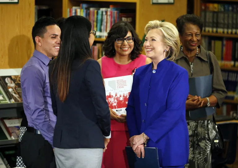 Hillary Clinton, a 2016 Democratic presidential contender, speaks with a group, including students, about immigration at an event at Rancho High School Tuesday, May 5, 2015, in Las Vegas. (AP Photo/John Locher)