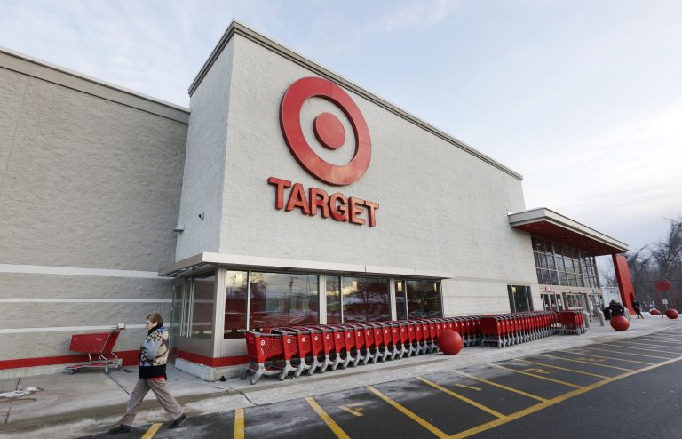 In this Dec. 19, 2013, file photo, a passer-by walks near an entrance to a Target retail store in Watertown, Massachusetts.