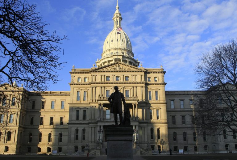 In a Dec. 12, 2012 photo, the statue of Gov. Austin Blair, the war governor (1861- 1864), is silhouetted against the state Capitol in Lansing, Mich. (AP File)