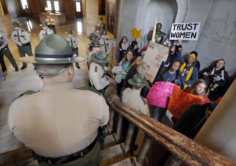 State troopers watch as abortion rights protesters stand in the Capitol in Nashville, Tenn. (AP Photo/Mark Humphrey)