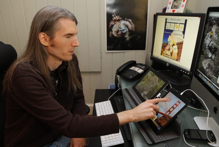   Dan Russell-Pinson is shown in his office at his home in Charlotte, N.C., Saturday, Dec. 15, 2012. Russell-Pinson, like many apps developers, is concerned that soon-to-be-issued federal rules intended to strengthen online privacy protection for children will cost him money and curb innovation in an industry that thrives on it. (AP Photo/Chuck Burton)  