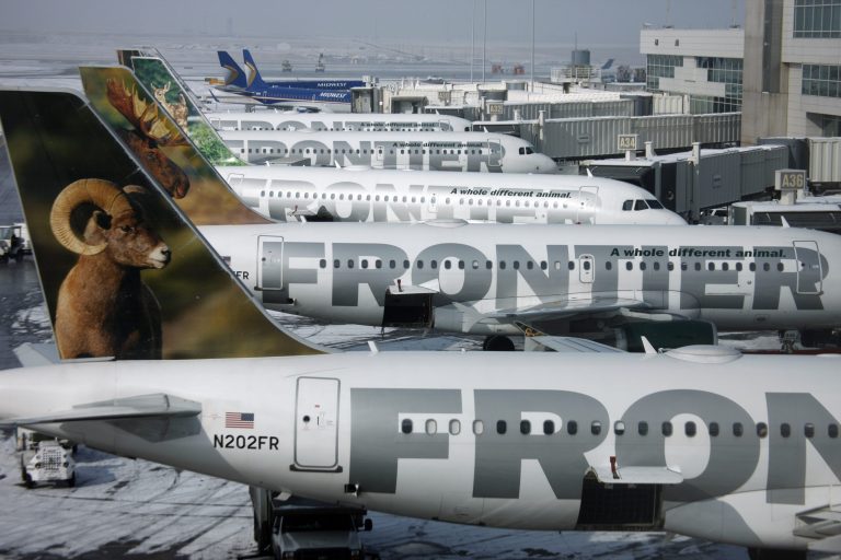 FILE - In this Feb. 22, 2010 file photo, Frontier Airlines jetliners sit stacked up at gates along the A concourse at Denver International Airport. Passengers flying Frontier Airlines will now have to pay extra to place carry-on bags in overhead bins or for advance seat assignments. The move comes as the Denver-based airline transforms itself into a fee-dependent airline, similar to Spirit Airlines or Allegiant Air _ the only other U.S. carriers to charge such fees. (AP Photo/David Zalubowski, File)