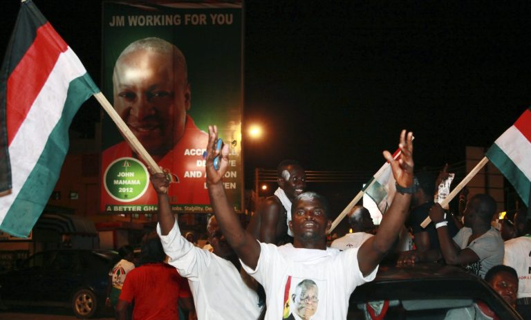   Supporters of President John Dramani Mahama celebrate in the streets after he was declared the winner of Ghana's presidential election, in Accra, Ghana, Sunday, Dec. 9, 2012. President Mahama on Sunday was declared the winner despite widespread technical glitches with the machines used to identify voters and protests by the country's opposition which claims the vote was rigged. (AP Photo/Christian Thompson)  