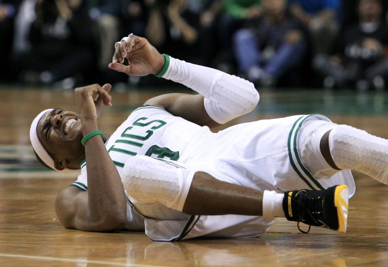   Boston Celtics guard Rajon Rondo grimaces as he hits the floor during the second quarter in Game 6 of the NBA basketball Eastern Conference finals against the Miami Heat, Thursday, June 7, 2012, in Boston. (AP Photo/Elise Amendola)  