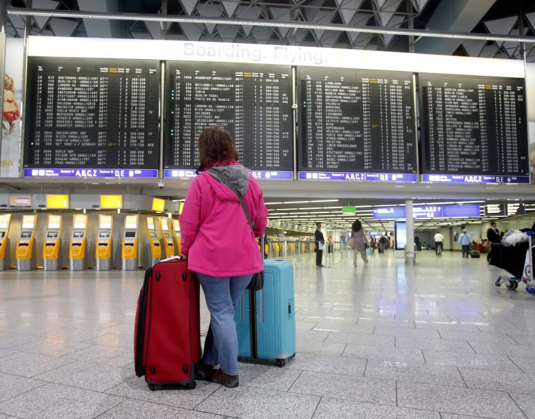 A passenger stands in the terminal at the Frankfurt airport as Lufthansa pilots went on a three-day strike in Frankfurt, Germany, Wednesday, April 2, 2014. Germany's Lufthansa said it has canceled almost 900 domestic and intercontinental flights on the first day of a three-day strike by the pilots' union. Airline spokeswoman Barbara Schaedler said that up to 900 flights were canceled for Wednesday and that it expects to cancel about 3,800 flights altogether, affecting more than 425,000 passengers.  (AP Photo/Michael Probst)