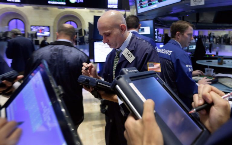 FILE - In this Sept. 18, 2014, file photo, trader Damian Bagarozza, center, works on the floor of the New York Stock Exchange. On Sept. 18, the U.S. stock market was at a record high after a relatively uneventful summer. Long-term interest rates were heading higher, a sign that investors expected steady growth in the U.S. economy. (AP Photo/Richard Drew, File)