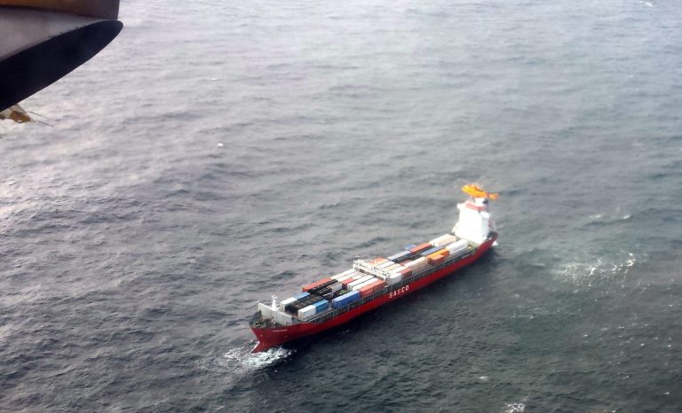 In this aerial photo provided by the Department of National Defense Maritime Forces Pacific, a Canadian Coast Guard helicopter flies near a Russian container ship, carrying hundreds of tons of fuel drifting without power in rough seas off British Columbia's northern coast on Friday, Oct. 17, 2014. The Canadian Forces' joint rescue coordination center in Victoria said the Russian carrier Simushir lost power late Thursday night off Haida Gwaii, also known as the Queen Charlotte Islands, as it was making its way from Washington state to Russia. (AP Photo/The Canadian Press, Department of National Defense Maritime Forces Pacific)