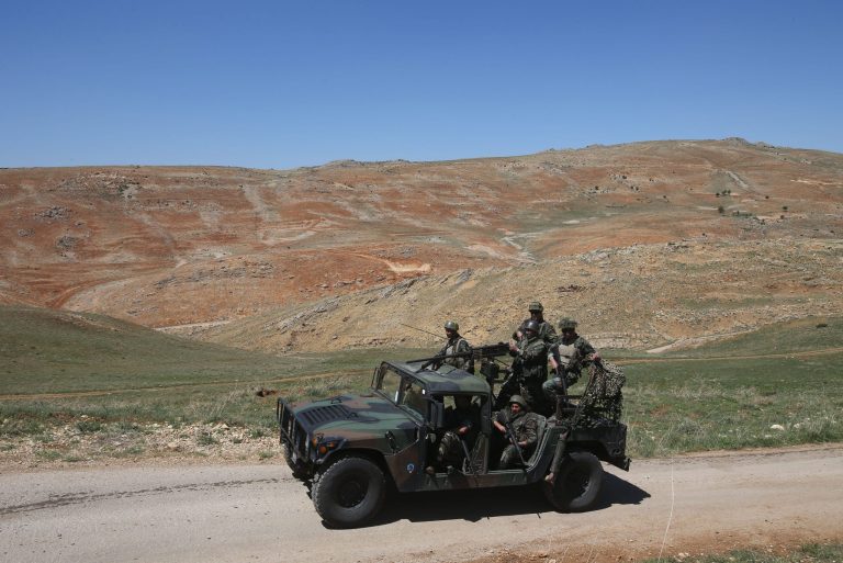 In this picture taken on Tuesday, April 22, 2014, Lebanese army soldiers patrol a road near Ras al-Haref mountain at the unmarked Lebanese-Syrian border, eastern Lebanon. More recently, the unmarked border between the two Arab neighbors, Syria and Lebanon, has become a source of friction in the region. Lebanese militants, fighting on the opposing sides in Syria's civil war have been moving troops and weapons freely over the 365-kilometer (226-mile) invisible frontier. Syrians fleeing their country's bloodshed keep pouring into Lebanon, with most Syrian crossing into Lebanon without being checked by officials at half a dozen border posts. (AP Photo/Hussein Malla)