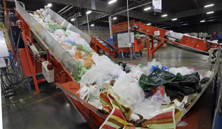 FILE-This Friday, Jan. 24, 2014 file photo conveyors carry mixed plastic into a device that will shred recycle them at a plastics recycling plant in Vernon, Calif. Gov. Jerry Brown has signed legislation on Tuesday, Sept. 30, 2014 imposing the nation's first statewide ban on single-use plastic bags.  (AP Photo/Reed Saxon,File)