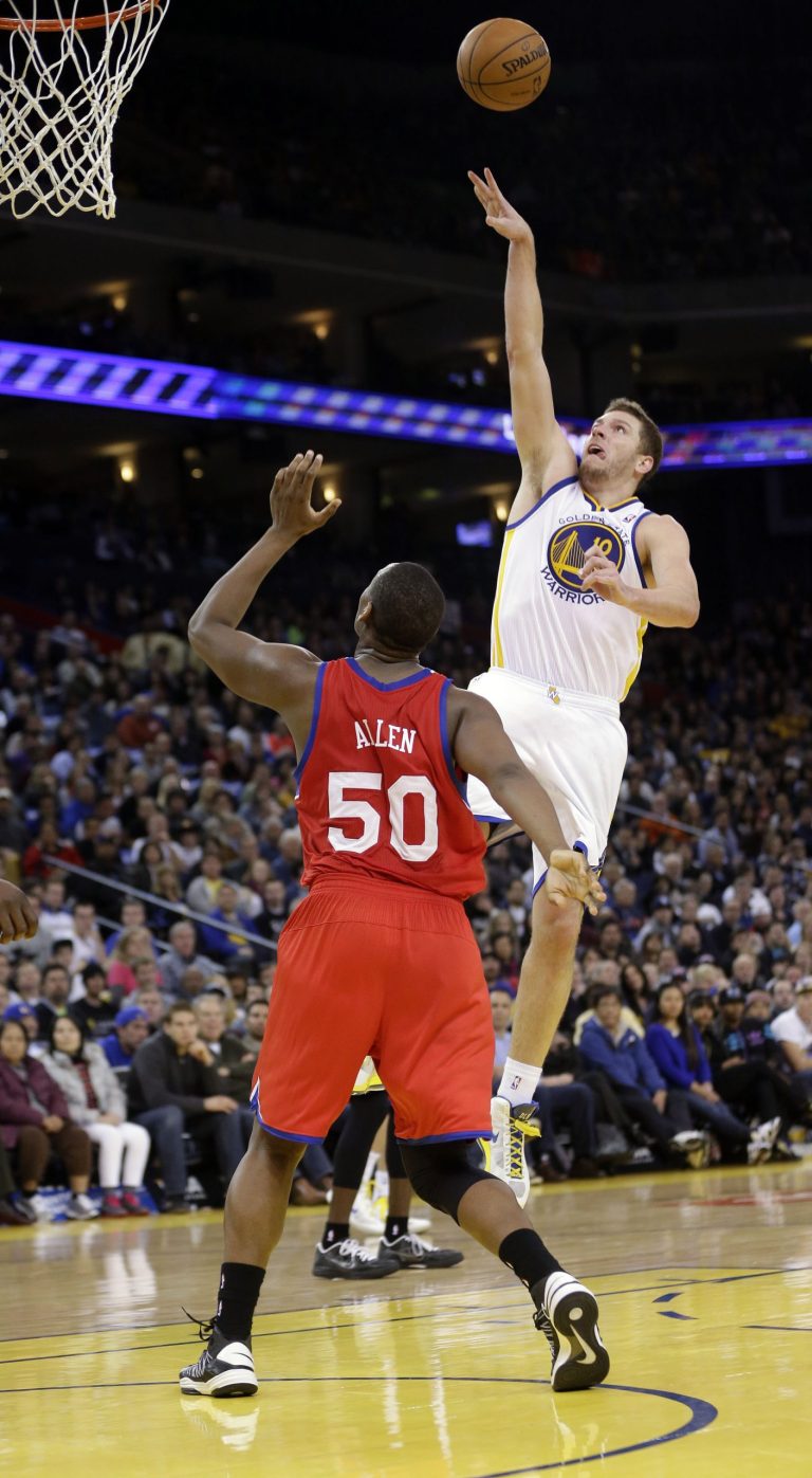   Golden State Warriors' David Lee (10) shoots to score over Philadelphia 76ers' Lavoy Allen (50) during the second half of an NBA basketball game in Oakland, Calif., Friday, Dec. 28, 2012. Golden State won 96-89. (AP Photo/Marcio Jose Sanchez)  