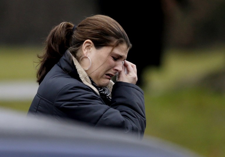   A mourner leaves the funeral service of Sandy Hook Elementary School shooting victim, Jack Pinto, 6, Monday, Dec. 17, 2012, in Newtown, Conn. Pinto was killed when a gunman walked into Sandy Hook Elementary School in Newtown Friday and opened fire, killing 26 people, including 20 children.(AP Photo/David Goldman)  