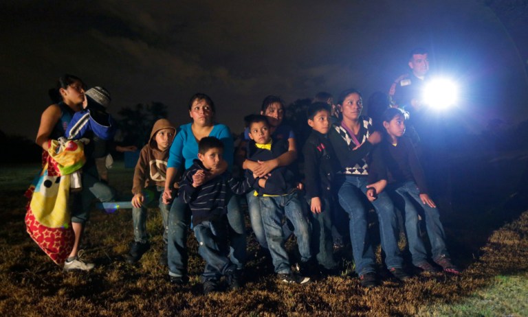 A group of immigrants from Honduras and El Salvador who crossed the U.S.-Mexico border illegally are stopped in Granjeno, Texas. (Eric Gay, AP)