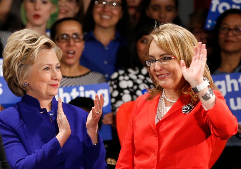Democratic presidential candidate Hillary Clinton applauds former Arizona congresswoman Gabrielle Giffords, right, a supporter and anti-gun advocate. (AP Photo/Kathy Willens)