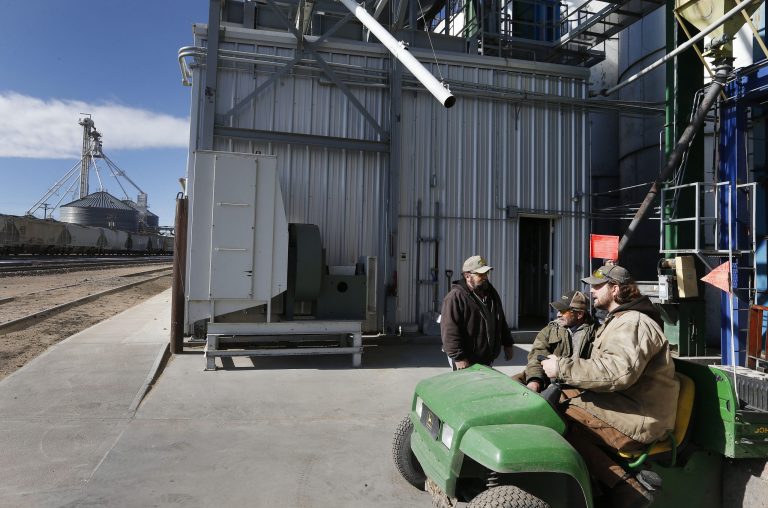 Workers talk at Global Harvest Foods, which produces birdseed and other grains, in the rural town of Akron, the county seat of Washington County, Colo. (AP /Brennan Linsley)
