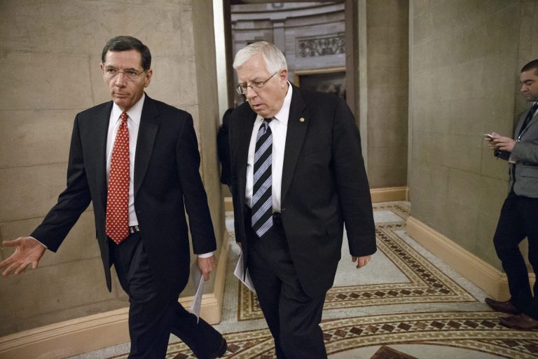 Sen. John Barrasso, R-Wyo., left, and Sen. Mike Enzi, R-Wyo., walk through a corridor at the Capitol following a closed-door meeting in Washington, Wednesday, Feb. 11, 2015. (AP Photo/J. Scott Applewhite)