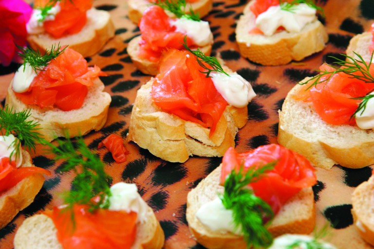 FILE- This Sunday, Dec. 2004 file photo, shows smoked salmon on toasted rye rounds with dilled cream cheese and sour cream. Smoked salmon tainted with salmonella bacteria has sickened hundreds of people in the Netherlands and the United States, sparking a major recall health authorities said Tuesday, Oct. 2, 201. (AP Photo/Mike Hentz, File)