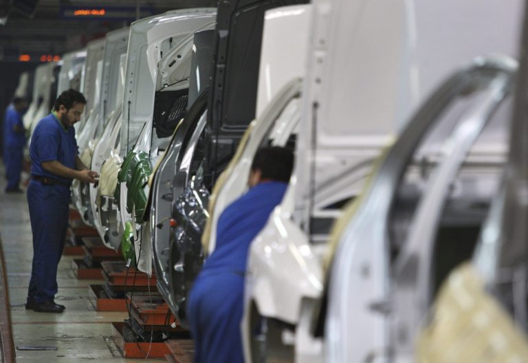 FILE - In this Feb. 7, 2009 file photo, Iranian workers assemble cars at the Iran Khodro automobile manufacturing plant, the biggest car manufacturing company in the Middle East,  just outside Tehran, Iran. For many business leaders, Iran is a mouthwatering emerging market, and they could soon find themselves heading to Iran to secure new deals following the suspension of the first international sanctions. (AP Photo/Vahid Salemi, File)