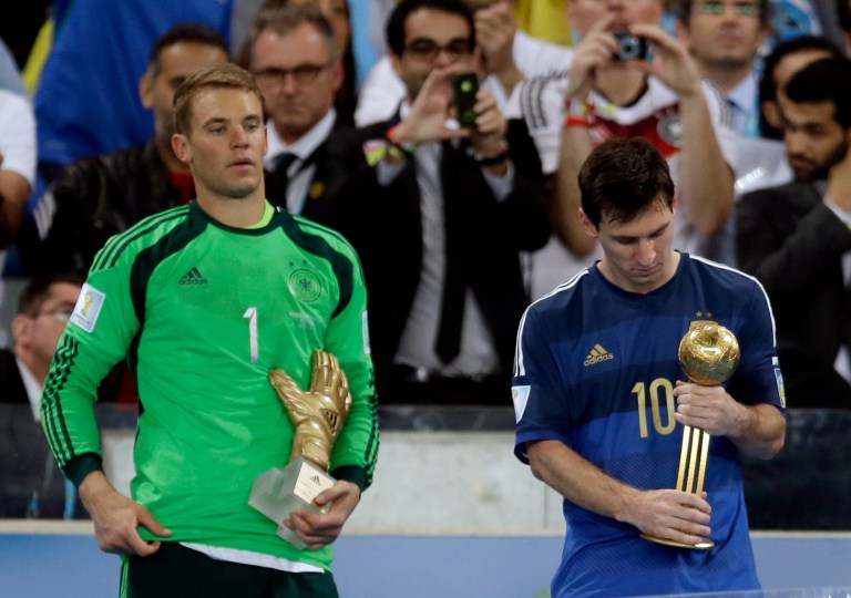 Germany's goalkeeper Manuel Neuer, recipient of the Golden Glove trophy, stands next to Argentina's Lionel Messi after he receive the Golden Ball trophy following Germany's 1-0 victory over Argentina after the World Cup final soccer match between Germany and Argentina at the Maracana Stadium in Rio de Janeiro, Brazil, Sunday, July 13, 2014. (AP Photo/Natacha Pisarenko)