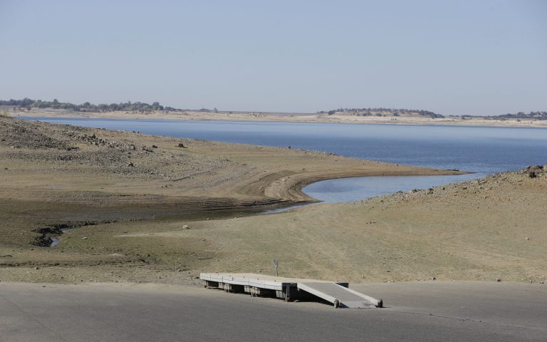 FILE - In the Oct. 6, 2014 file photo, a dock sits high and dry at the end of a boat ramp yards away from the edge of Folsom Lake near Folsom, Calif.  Gov. Jerry Brown said Monday, Oct. 20, 2014 while speaking at a water conference at Stanford University that he will focus on a long-term strategy to cope with California's water problems if he is re-elected in November. (AP Photo/Rich Pedroncelli,file)