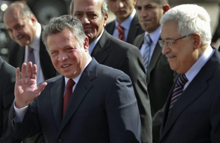   King Abdullah II of Jordan, left, gestures during a welcoming ceremony with Palestinian President Mahmoud Abbas, prior to their meeting in the West Bank city of Ramallah, Thursday, Dec. 6, 2012. Jordanâs King Abdullah II has begun a brief visit to the West Bank in support of Palestinian President Mahmoud Abbasâ successful bid for U.N. recognition of a state of Palestine. (AP Photo/Majdi Mohammed)  