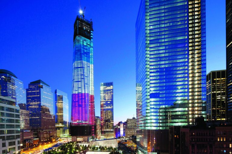 The tower known as 1 World Trade Center, left, the National September 11 Memorial, bottom left, and 4 World Trade Center, right, are bathed in light, Tuesday, Sept. 11, 2012 in New York. Tuesday is the eleventh anniversary of the terrorist attacks of Sept. 11, 2001. (AP Photo/Mark Lennihan)
