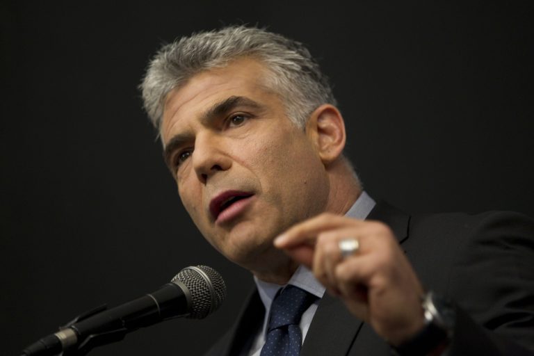 FILE - In this Tuesday, Oct. 30, 2012 file photo, Israeli Yair Lapid, a popular former TV anchorman, head of the new centrist party Yesh Atid, delivers a speech in the Ariel college of Judea and Samaria in the West Bank Jewish settlement of Ariel. In an interview with the Associated Press Monday Aug. 11, 2014, Israeli Finance Minister Yair Lapid called on the international community to pull together a massive aid package for Gaza conditioned on the Palestinian Authority returning to power in place of the Islamic militant group Hamas. (AP Photo/Ariel Schalit, File)