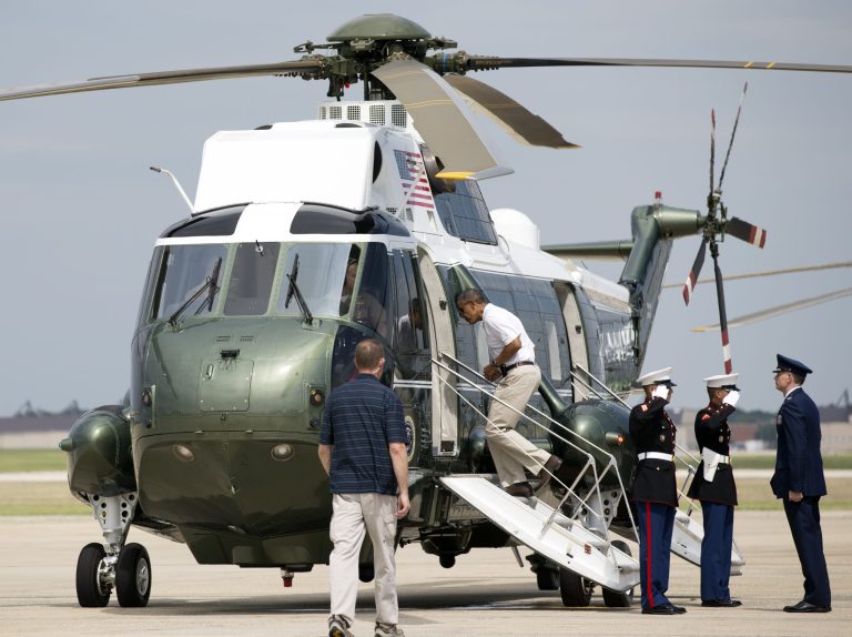   President Barack Obama, second from left, jogs up the ramp of Marine One as he leaves Andrews Air Force Base, Md., for a weekend in Camp David, Md., Saturday, Aug. 3, 2013. Sunday is the President's 52nd birthday. (AP Photo/Manuel Balce Ceneta)  