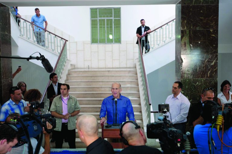 FILE - In this Tuesday, July 10, 2012 file photo, former Israeli Prime Minister Ehud Olmert speaks to the media after hearing the verdict in his trial, in Jerusalem's District Court. Olmert said on Thursday, July 12, 2012 that he would not return to politics, two days after he was acquitted of the central charges in a corruption trial. Speculation over whether he may return to political life has been rife since a Jerusalem court dismissed most of the counts against him on Tuesday. (AP Photo/Ariel Schalit, File)