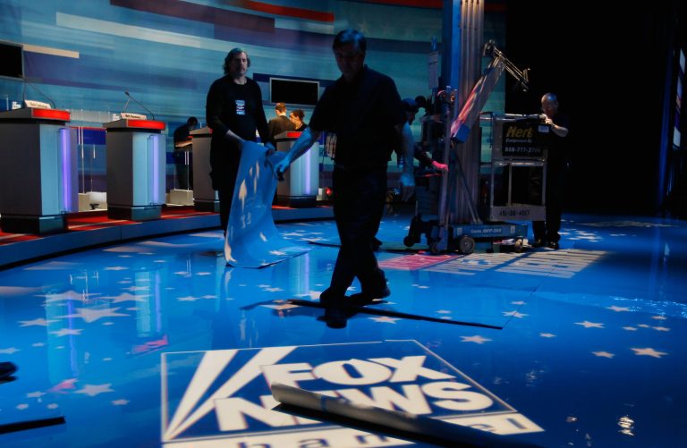 Workers prepare the stage for the Fox News/Wall Street Journal/South Carolina GOP debate at the Sheraton Myrtle Beach Convention Center on January 16, 2012 in Myrtle Beach, S.C. (Photo by Joe Raedle/Getty Images)