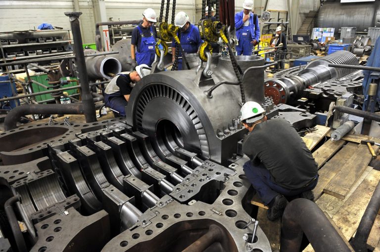 Technicians assemble a new steam turbine system in the hard coal-fired power station 'Block 6' of energy provider swb AG at the industrial harbour in Bremen, Germany, 31 July 2013. The new turbine will increase the power output of what is already swb's most powerful power station. 50 million euros will be invested inthe renovation of Block 6. Photo by: Ingo Wagner/picture-alliance/dpa/AP Images