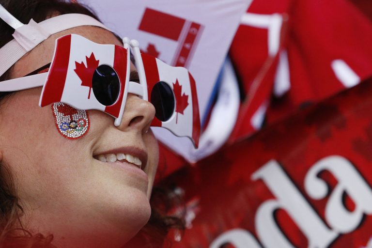 A Canadian fan watches the start of the women's gold medal ice hockey game between Canada and the United States at the 2014 Winter Olympics, Thursday, Feb. 20, 2014, in Sochi, Russia. (AP Photo/Julio Cortez)