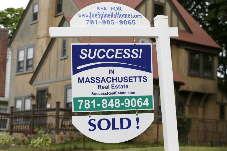 In this July 10, 2014 photo, a sign hangs in front of a recently sold home in Quincy, Mass. Real estate data provider CoreLogic reports on U.S. home prices in June 2014 on Tuesday, Aug. 5, 2014. (AP Photo/Michael Dwyer)