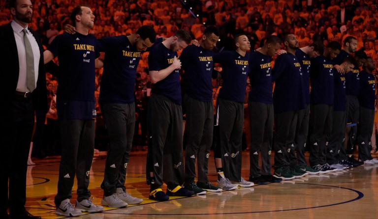 Utah Jazz players listen to the national anthem during Game 2 of an NBA basketball second-round playoff series against the Golden State Warriors, Thursday, May 4, 2017, in Oakland, Calif. (AP Photo/Marcio Jose Sanchez)