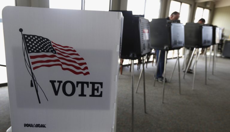 FILE - In this March 18, 2014 file photo, voters cast their ballots in the Illinois primary in Hinsdale, Ill. Illinois voters head to the polls next week to cast critical primary ballots for offices from U.S. president to county recorder. Ahead of the contests, a government watchdog group teamed up with a Chicago information technology company to examine voter records and Census data over four elections, an analysis they say hasn't been as easily accessible to the public before now. Officials with Illinois Campaign for Political Reform hope it willl contribute to more voter participation. (AP Photo/M. Spencer Green, File)