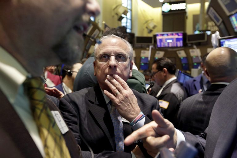   FILE - In this Friday, Dec. 14, 2012, file photo, Floor official Nicholas Brigandi, center, works on the floor of the New York Stock Exchange. Stocks are opening mixed on Wall Street as traders keep a close eye on budget talks in Washington as a deadline approaches for reaching a deal. (AP Photo/Richard Drew)  