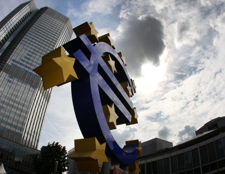 in front of the headquarter of the European Central Bank in Frankfurt, Germany, Tuesday, July 31, 2012. (AP Photo/Michael Probst)