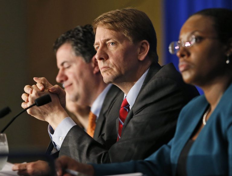 Republican Sens. Mike Lee and Ben Sasse want President-elect Trump to fire Richard Cordray, center, the head of the Consumer Financial Protection Bureau and are not waiting until Trump takes the oath of office to tell him so. (AP Photo/Steve Helber, File)